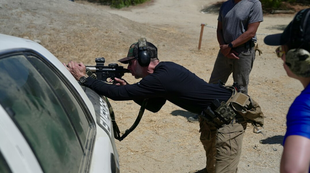 Trainer teaching students how to operate a broadcast camera