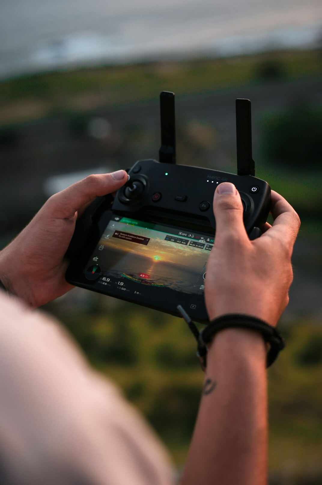 Camera operator flying a drone for aerial broadcast footage