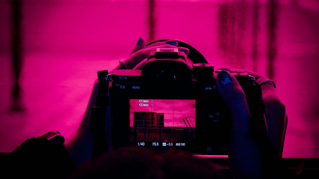 Camera operator filming with a professional broadcast camera